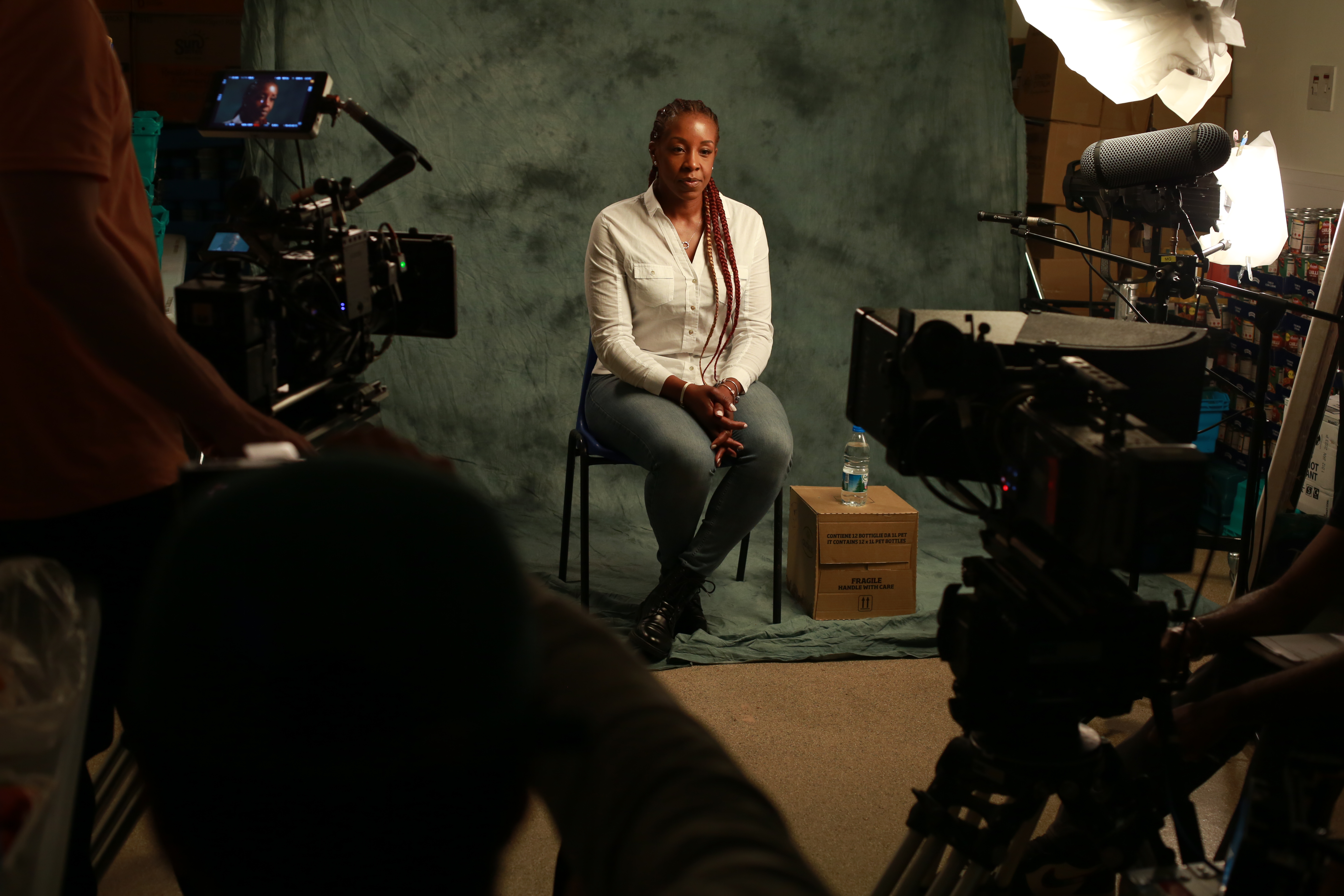 Jocelyn from RISE 365 behind a camera for Superheroes Wear Hoodies