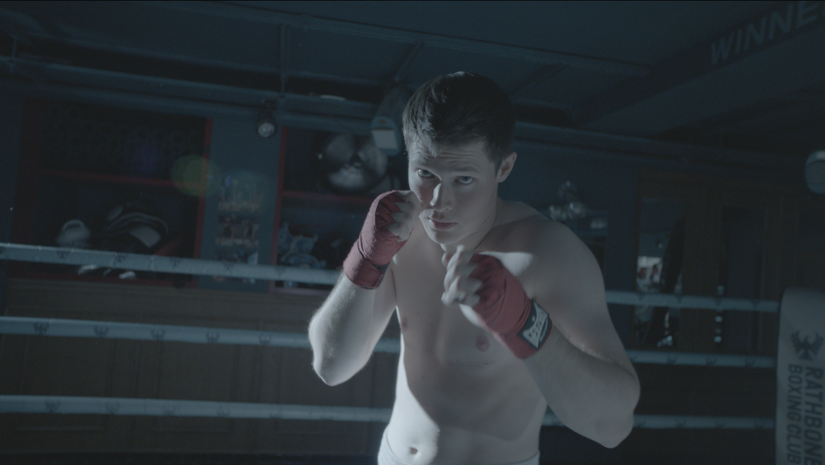 Jill faces the camera in a boxing stance.