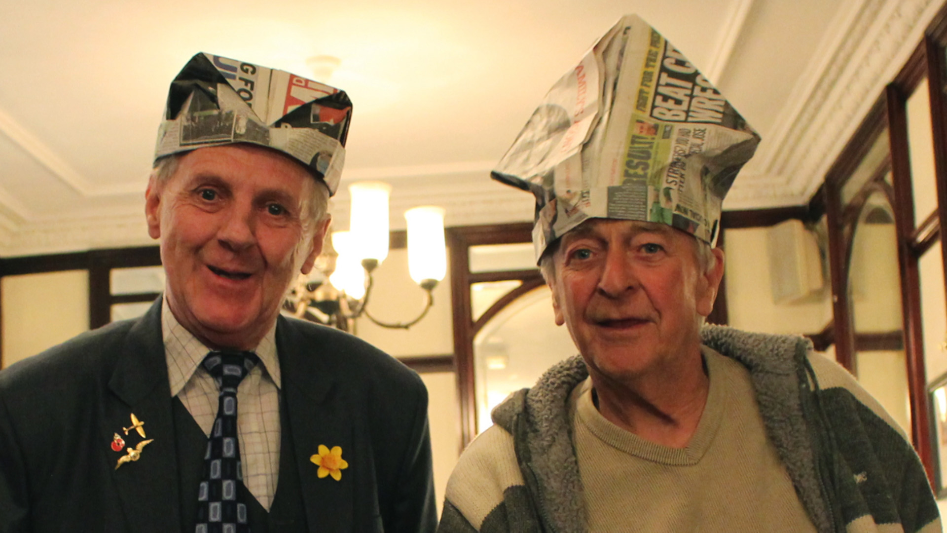 Newspaper employees wearing newspaper hats